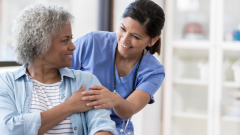 kind nurse with smiling older woman
